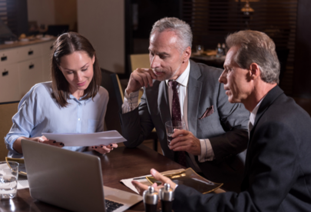 three people looking at a computer